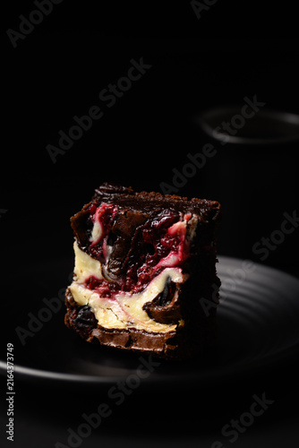Close-up of delicious homemade cranberry cream cheese brownies on a dark background
