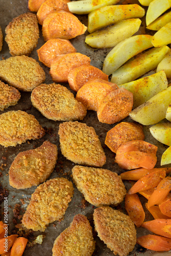 Vegan meat with roasted vegetables in a cooking pan.