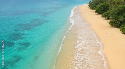 Tranquil Beach Scene With Soft Golden Sand And Clear Blue Ocean Waters Under Bright Sunlight