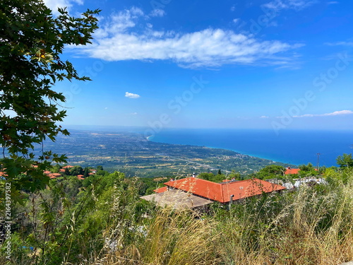 Cuadro en lienzo Unsurpassed panorama from the thickets of the mountain forest of the lush blue of the Aegean Sea on the horizon with coastal settlements on the slopes of the mountain hills
