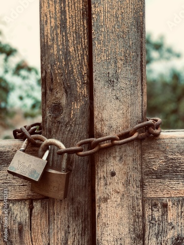 Old Wooden Gate Secured with Rusty Chain and Padlocks in Canary Islands