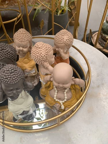 Small Buddha Statues Displayed on Round Mirrored Tray representing See No Evil Hear No Evil Speak No Evil