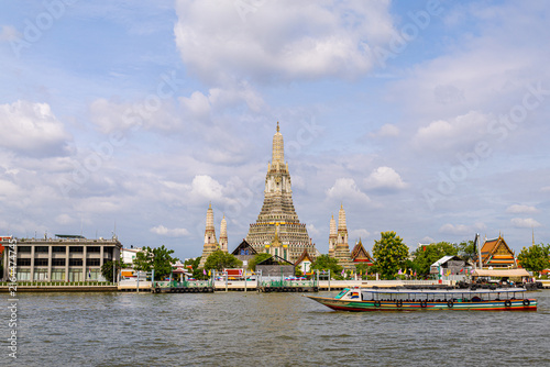 Wat Arun the famous Temple of Dawn sits on the west bank of the Chao Phraya River with travel boat
