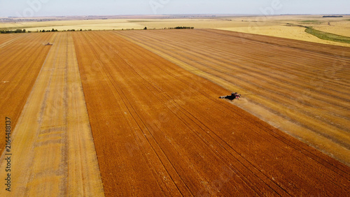 Foto Aerial View of Two Combine Harvesters Working in Golden Wheat Field