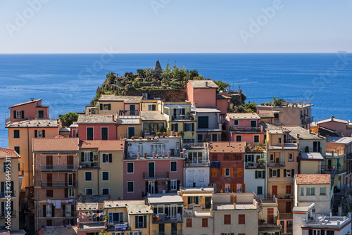 Manarola in Italy within the protected Cinque Terre landscape shows balconies and cultivated roofs from close telephoto architectural perspective.