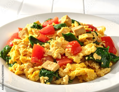 Savory Scrambled Eggs with Tofu, Spinach, and Tomatoes on a White Plate