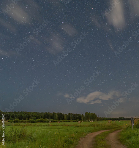 Title: Starry night sky over a rural road in Inčukalns, Latvia