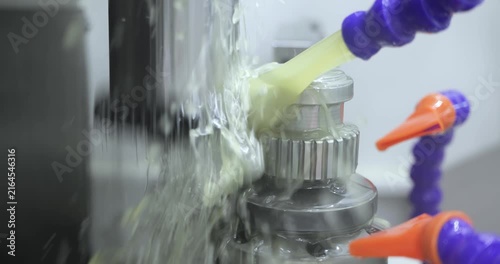 Industrial coolant spraying on CNC metal machining process.