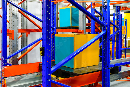 Industrial cardboard box package stored on automated racking system in smart logistics warehouse