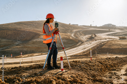 Land Surveyor Mapping Large Development Site with Precision Equipment