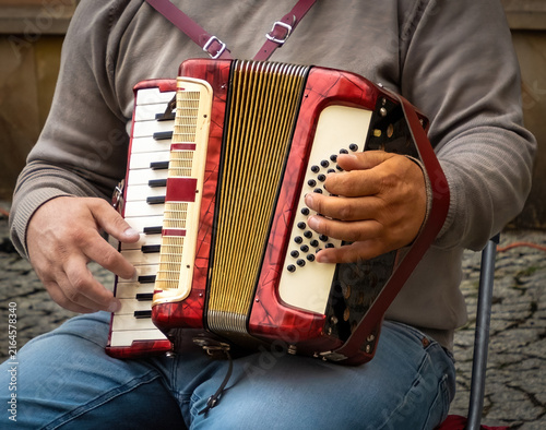 Bild auf Leinwand An Accordion on an mans lap