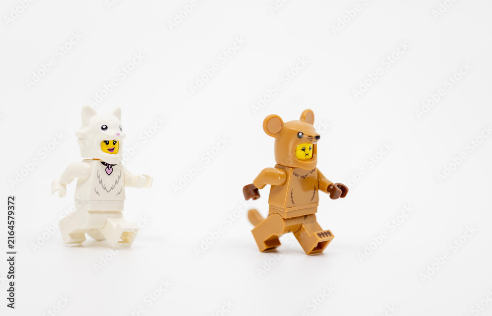 Naklejka premium Hong Kong, June 8, 2026: Two minifigures wearing cat and mouse costumes run in a playful hunting chase.