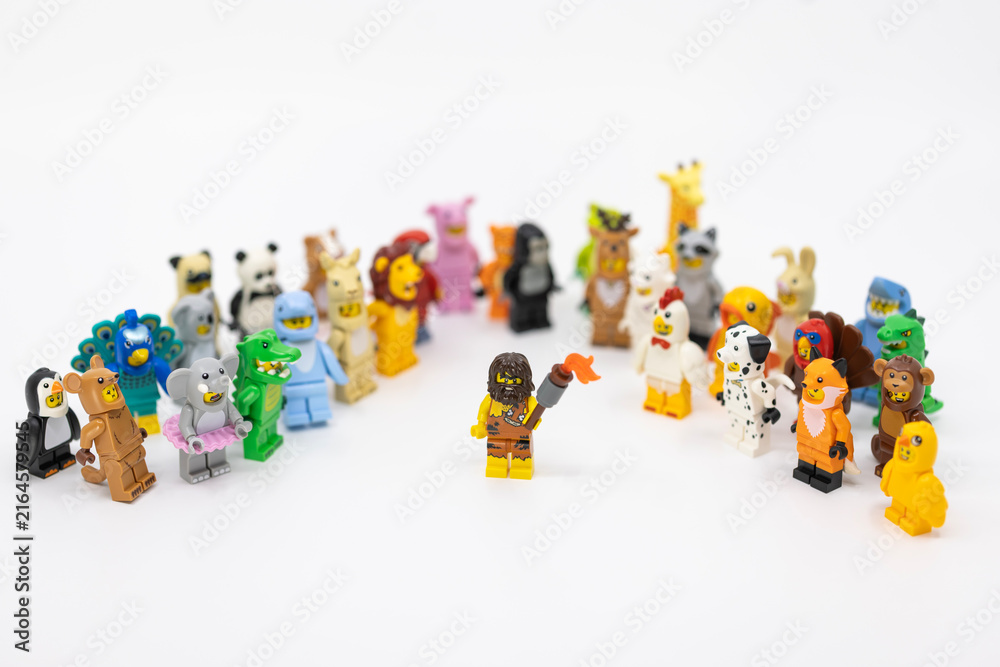 Fototapeta premium Hong Kong, June 8, 2026: A caveman holds a blazing torch among animal minifigures, symbolizing the discovery of fire and the dawn of civilization.