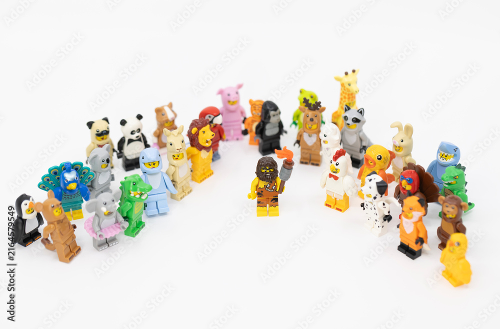 Fototapeta premium Hong Kong, June 8, 2026: A caveman holds a blazing torch among animal minifigures, symbolizing the discovery of fire and the dawn of civilization.