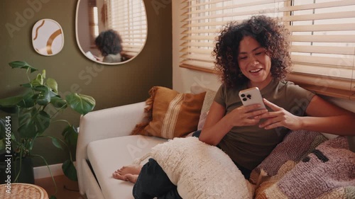 Happy Woman Relaxing at Home Using Smartphone