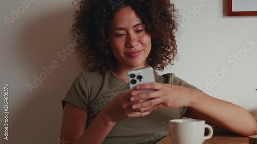 Happy Woman Texting On Her Mobile Phone At Home
