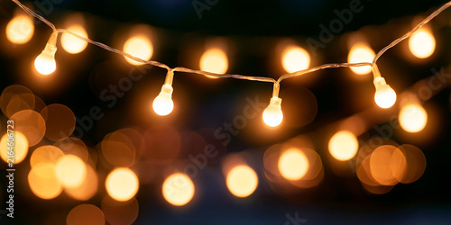Warm Glowing String Lights Hanging Against a Dark Background