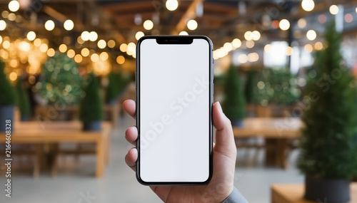 Hand holding mobile phone with empty screen for mockup