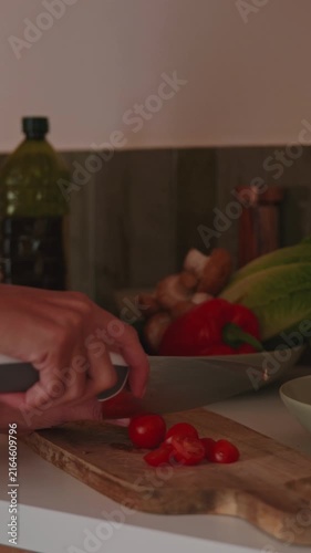 Healthy Cooking: Hands Chopping Fresh Tomatoes In Kitchen