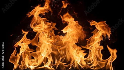 Orange and yellow flames rise against a dark background creating a fiery display