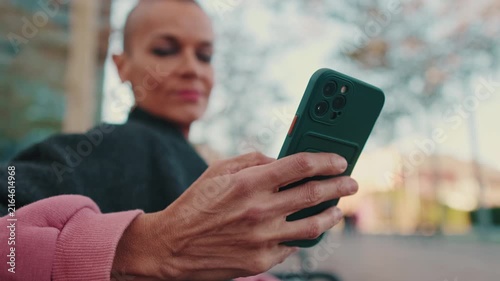 Modern Woman Focused On Her Smartphone Outdoors