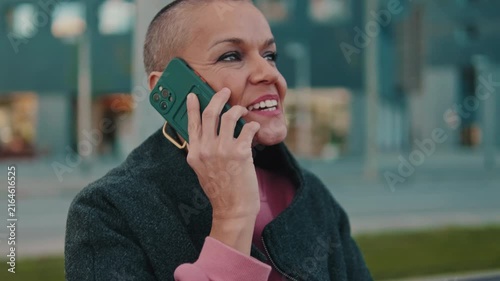 Smiling Woman Talking on Smartphone Outdoors