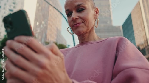 Modern Woman Browsing Smartphone in Urban Cityscape