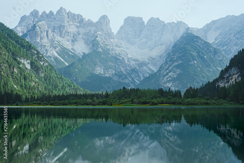 Obraz na plátně Scenic view of Lago di Braies in the Dolomites, Italy, with dramatic mountain peaks reflected in calm turquoise water and a peaceful alpine landscape