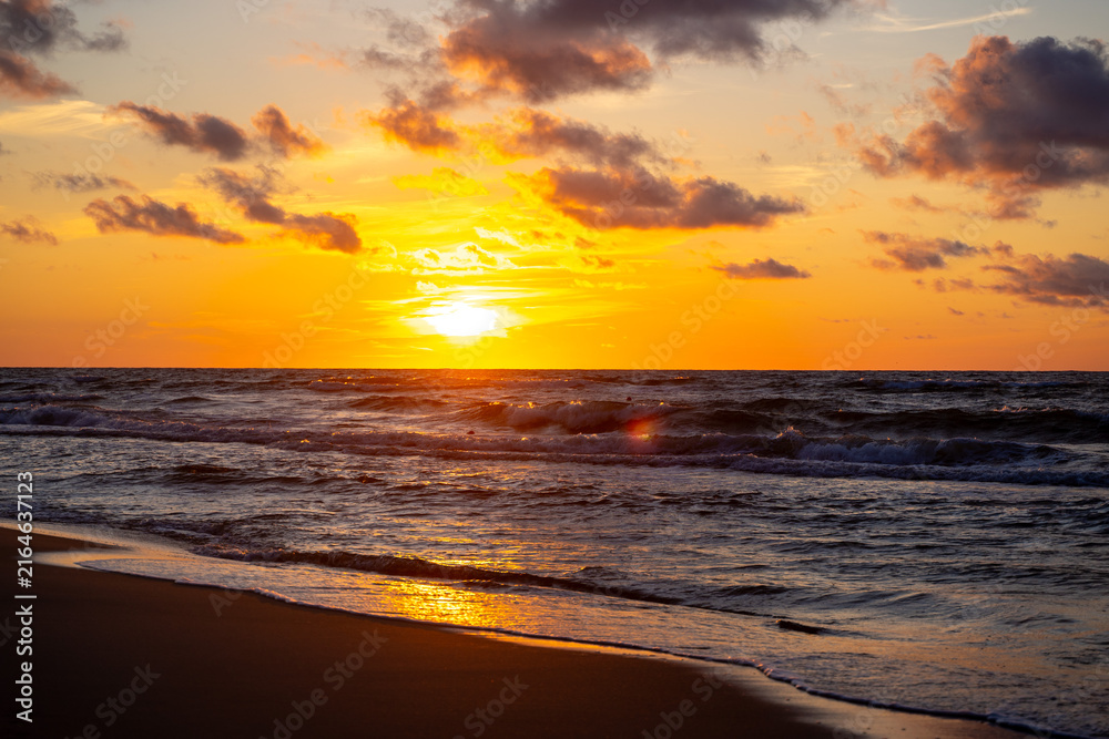 Obraz premium Sunset on the beach, waves, sea, summer.