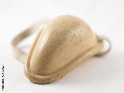Gold athletic protective cup isolated on white for sports safety and medical use