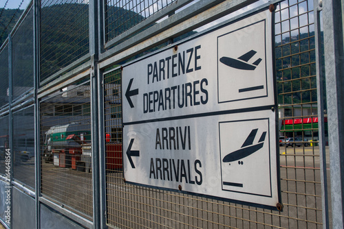 Airport departures arrivals sign on perimeter fence in Lugano Switzerland