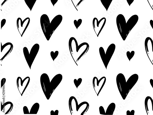 Seamless pattern featuring hand-drawn black hearts on a white background for romantic and valentine decor