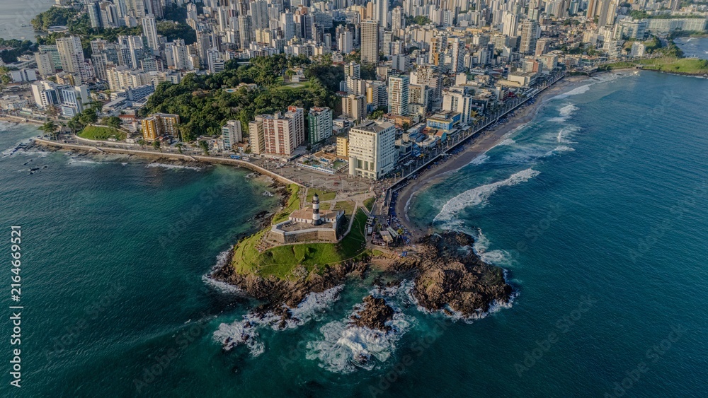 Fototapeta premium Aerial view of Farol da Barra fort and rocky shoreline