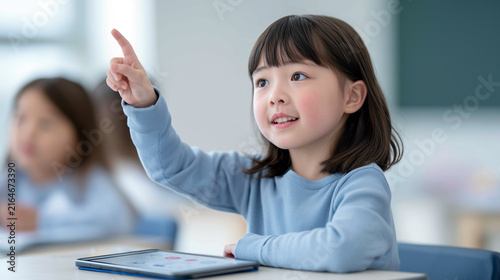 Portrait of a schoolgirl in a modern classroom with a tablet on the desk.