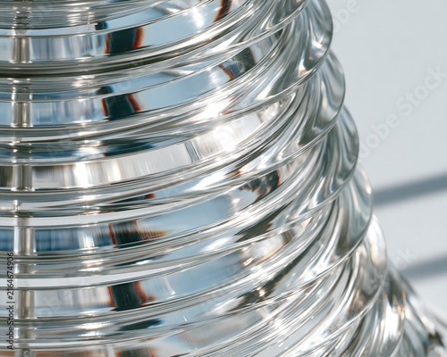 Shiny, ribbed silver cylinder reflecting light.