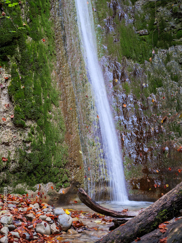 Autumn Forest Waterfall Flowing Over Mossy Rock Wall