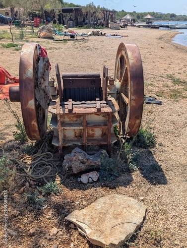 Fotografie Old rusty vintage machine on a sunny beach in Croatia