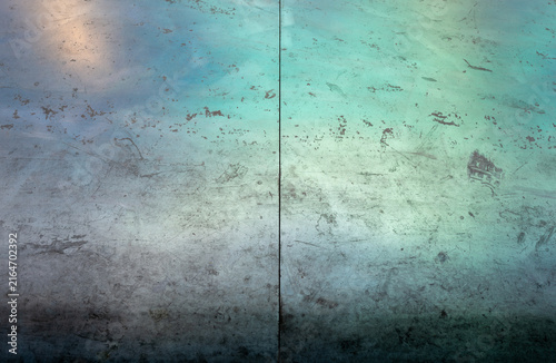 Weathered industrial metal panel with greenish-blue oxidation and texture
