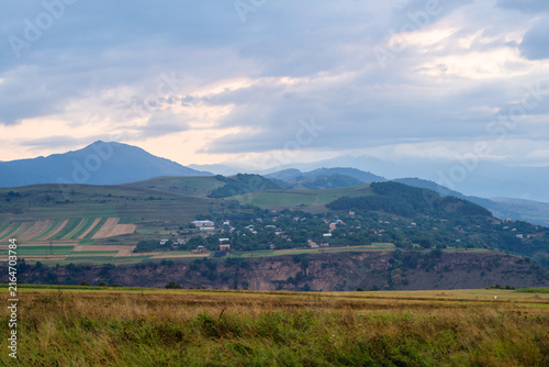 Dzoragyugh village with sunset clouds and forest mountains, Armenia