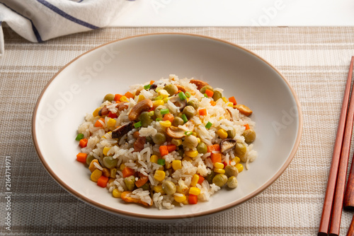Whole Grain Fried Rice.vegan fried rice with shiitake mushroom ,Cashew nuts ,carrot ,corn and green pea in white plate.Vegetarian Festival.