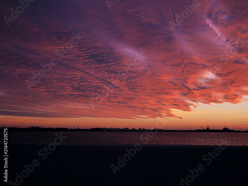 Принти на полотні Orange and red sunset sky with glowing clouds, dramatic evening atmosphere and colorful cloudscape background