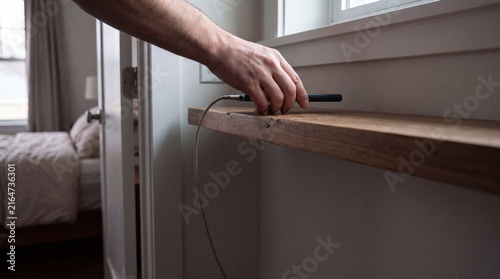 Person Leaves Charging Smartphone Outside Bedroom Before Sleep