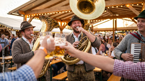 Oompah band playing instruments at an outdoor festival with beer  