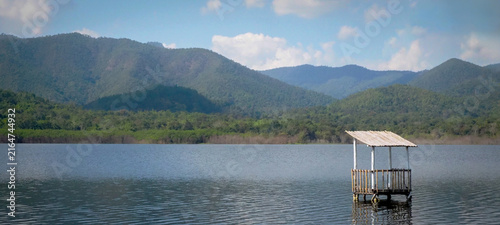 Bild auf Leinwand Wooden Pier Hut in Mountain Lake Landscape or background or website header