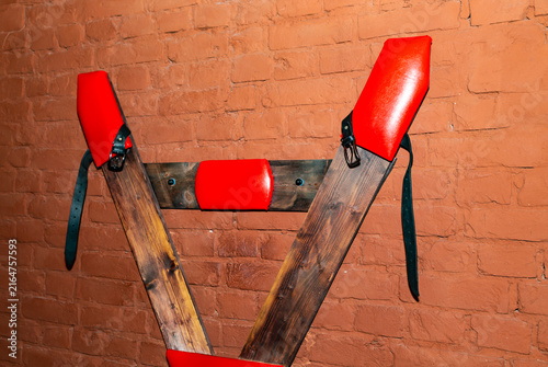 SM cross or Andreaskreuz is used in the BDSM scene on red background
