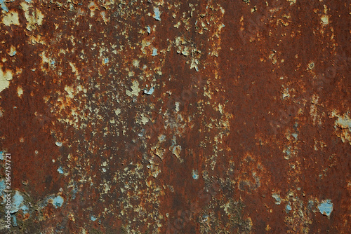 Фотография Macro shot of severely oxidized rusty iron with remnants of peeling blue and white paint, highlighting coarse textures and natural degradation on an industrial metal surface