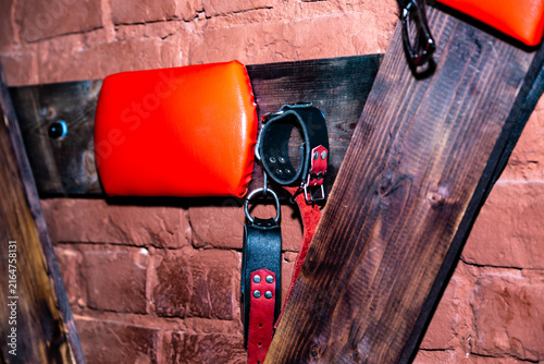 SM cross or Andreaskreuz is used in the BDSM scene on red background