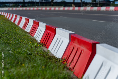 Fotografie Red and white modular plastic traffic barriers deployed along a circuit track fo
