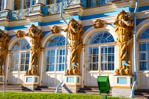 Golden statues guard elegant blue and white windows