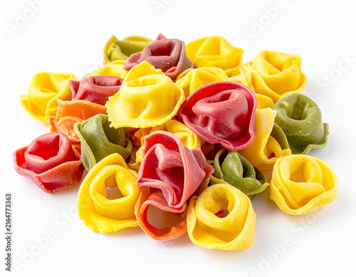 Fresh tortellini tri-colored pasta, white backdrop. AI